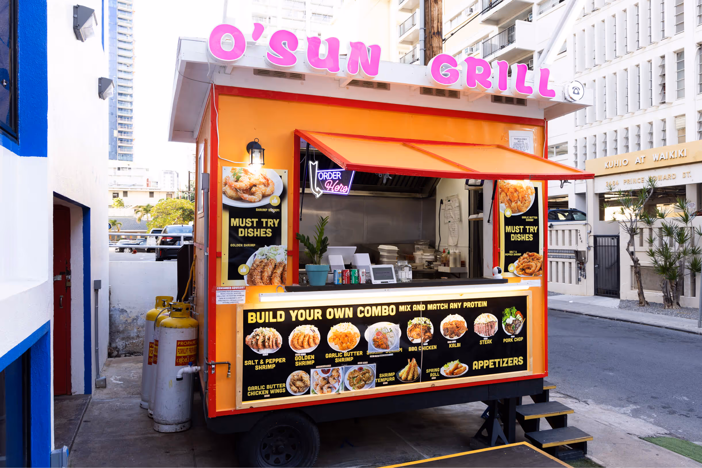 O'Sun Grill food truck with illuminated menu showcasing shrimp and various grilled protein dishes on a city street.