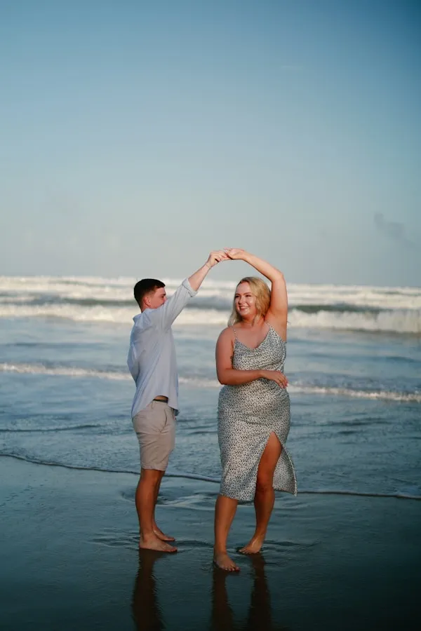 Couple dancing on a beach at sunset
