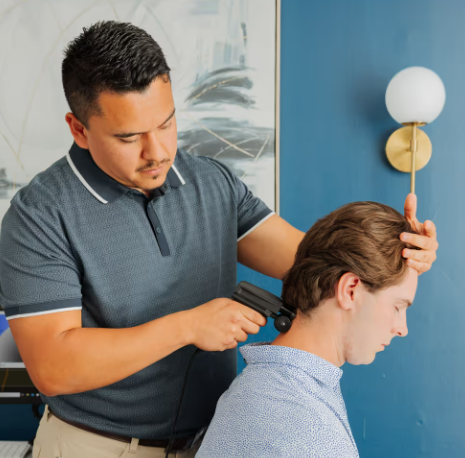 Patient working with a provider at a chiropractic clinic in Mauldin, SC for posture assessment and back pain treatment