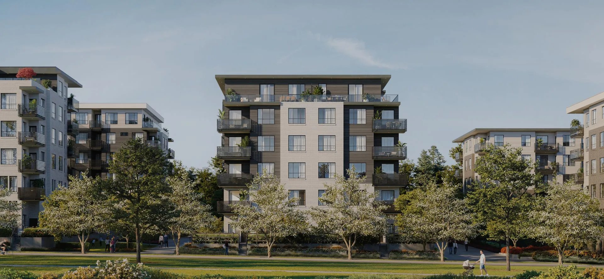 Modern multi-story apartment buildings surrounded by trees and green lawns with people walking and a man pushing a stroller at Queens by Dawson + Sawyer in bear creek