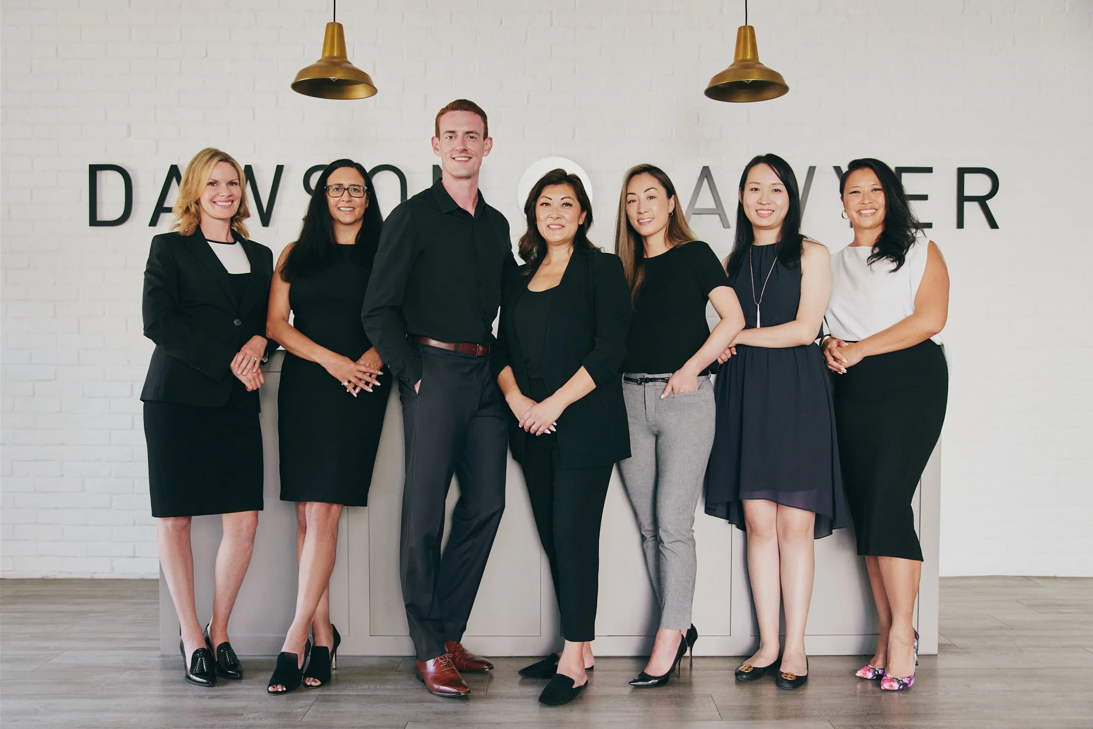 The Dawson + Sawyer sales team in front of the reception desk