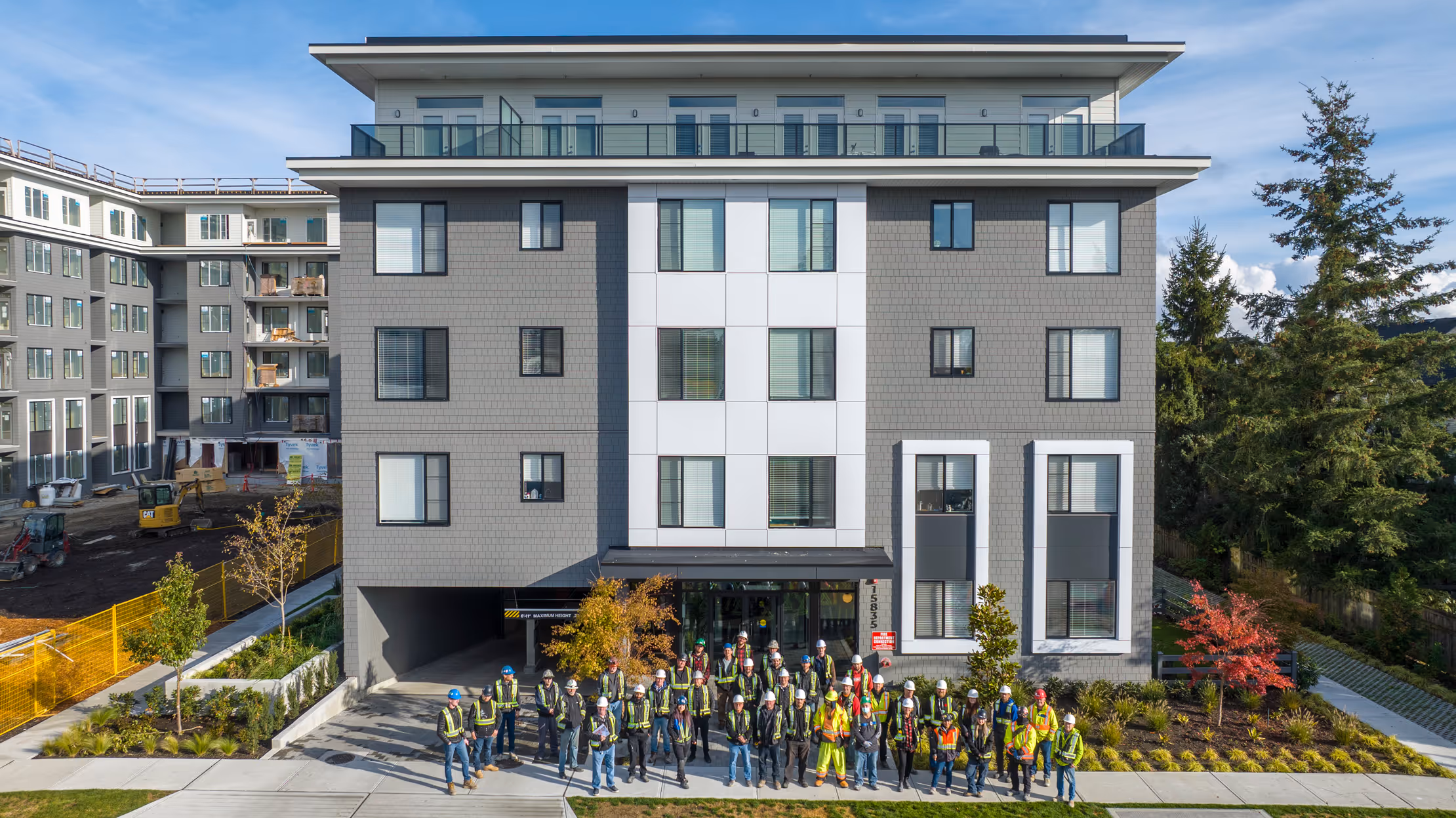 Dawson + Sawyer construction team in front of new condo project in Surrey, BC