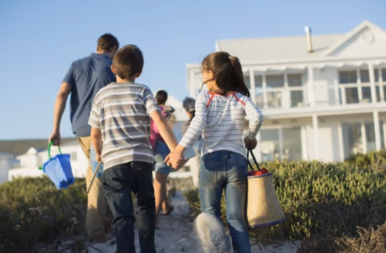 Family on beach after happy treatment from first light pest control