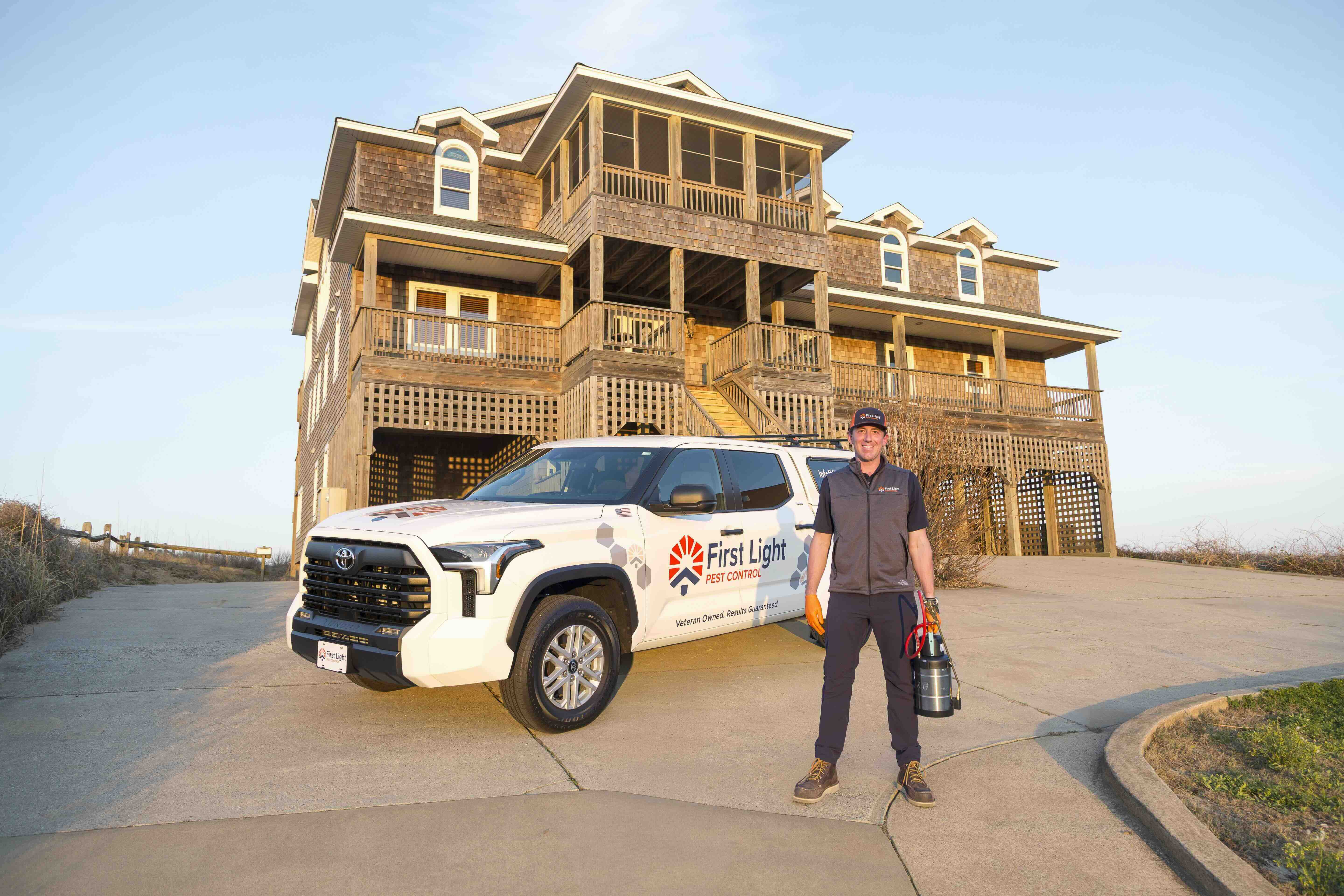 Professional pest technician treating the exterior of a home to prevent insects and pests.