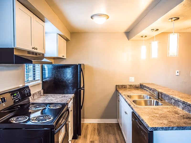 Kitchen with white cabinets and black appliances