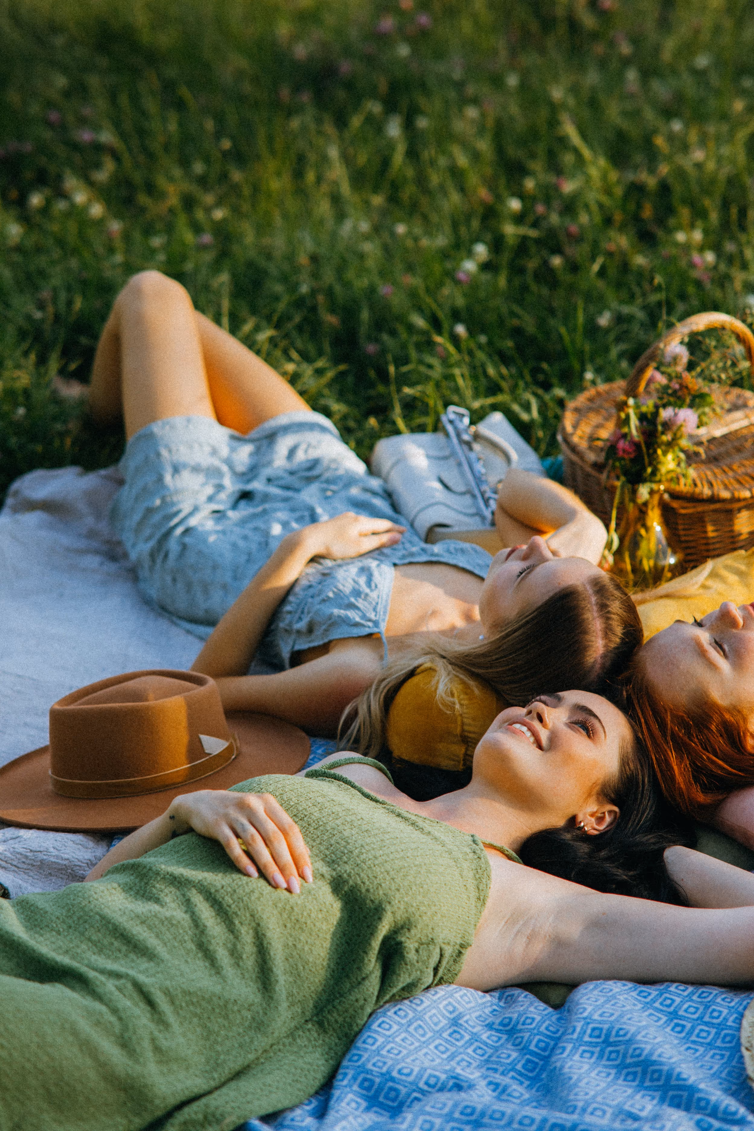 Three girls laying in the grass stock image