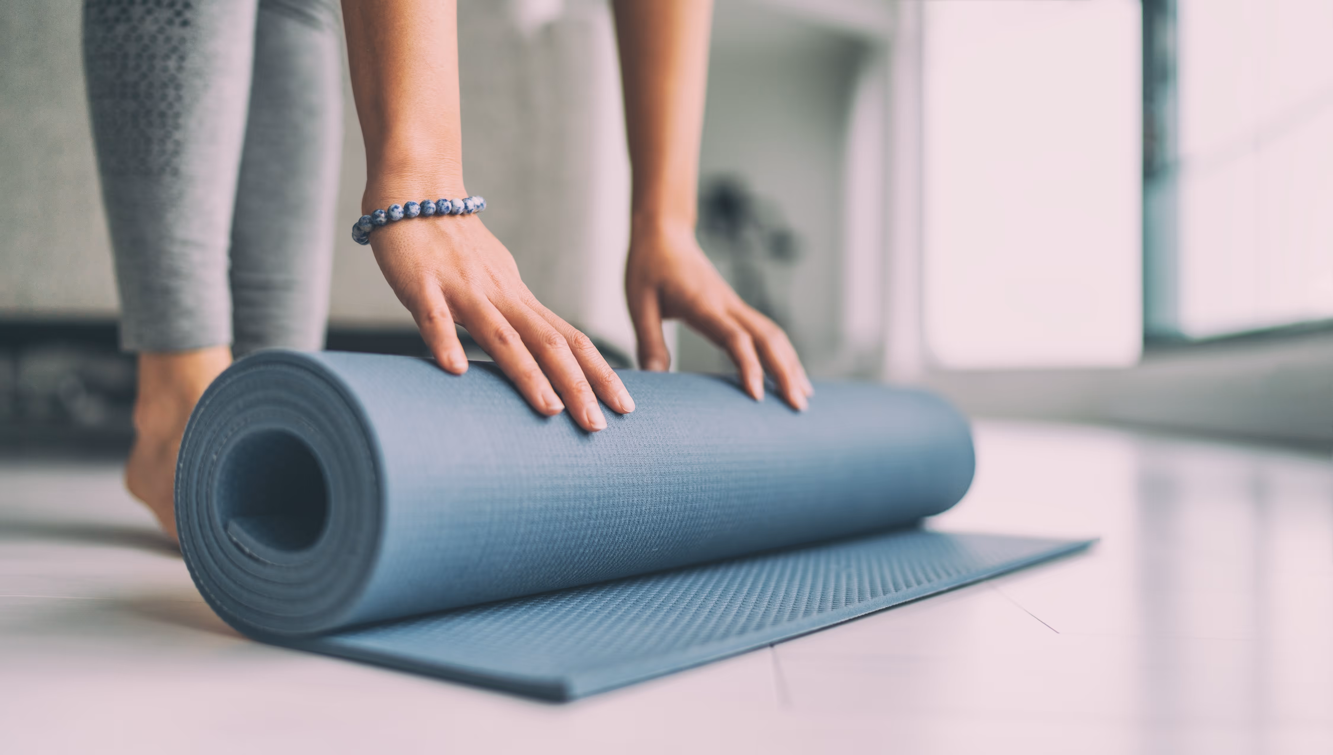 Rolling up yoga mat stock image