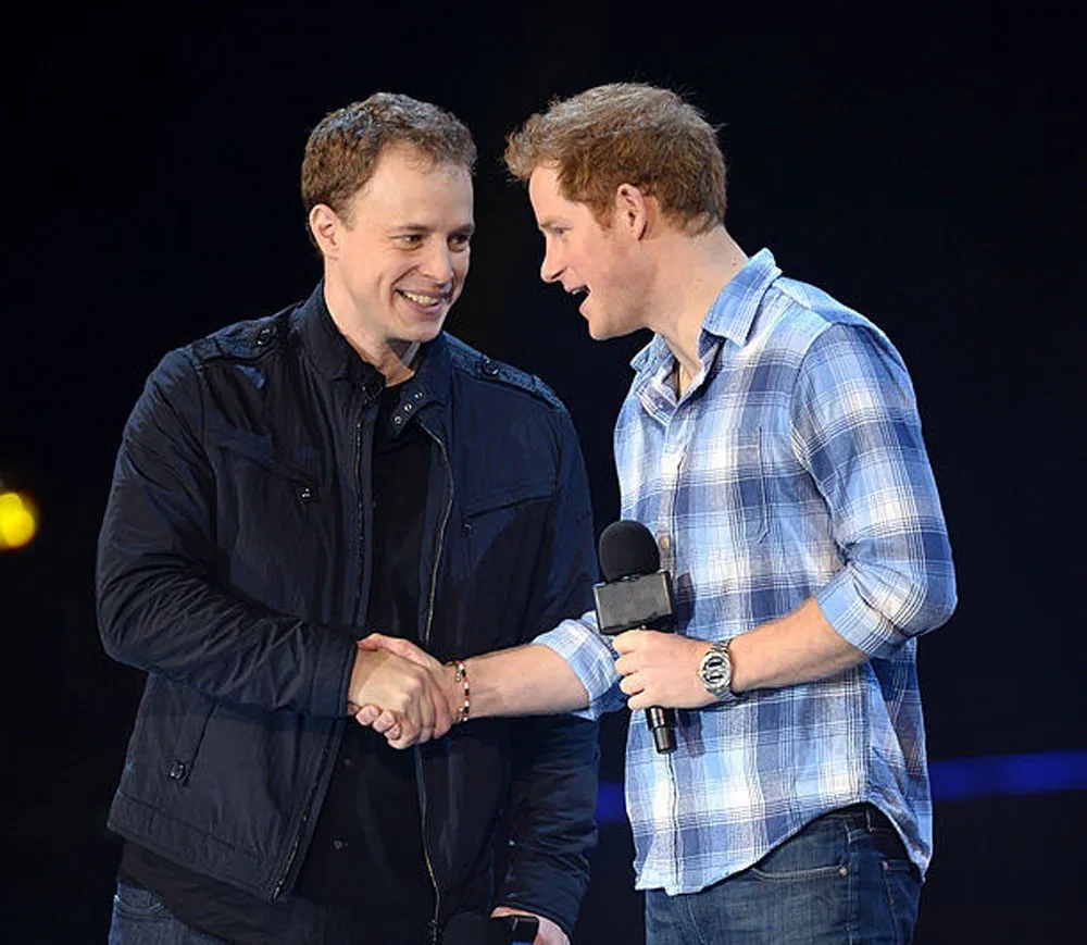 a couple of men standing next to each other shaking hands