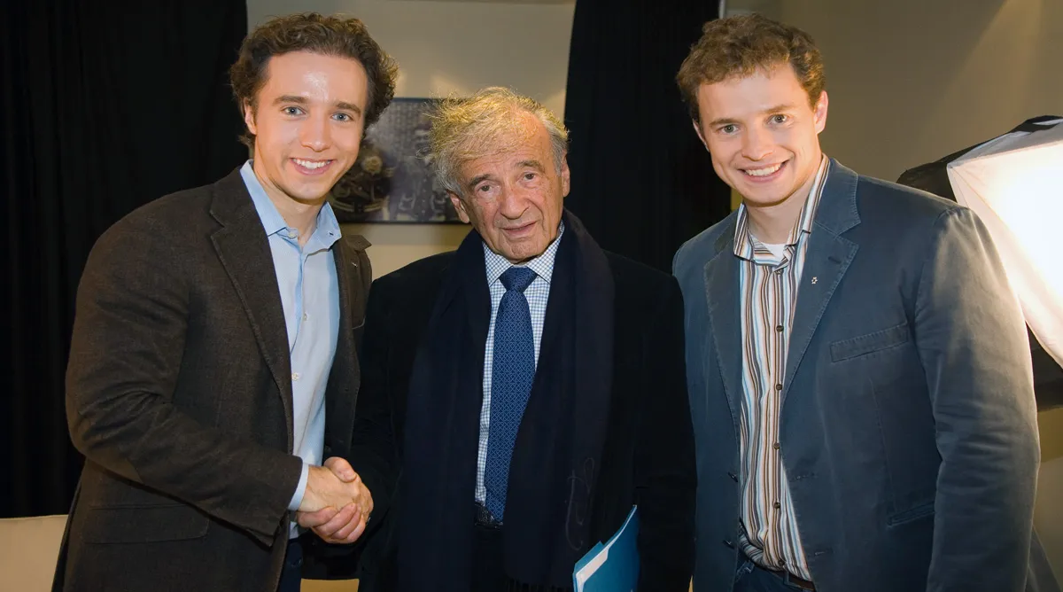 a group of three men standing next to each other