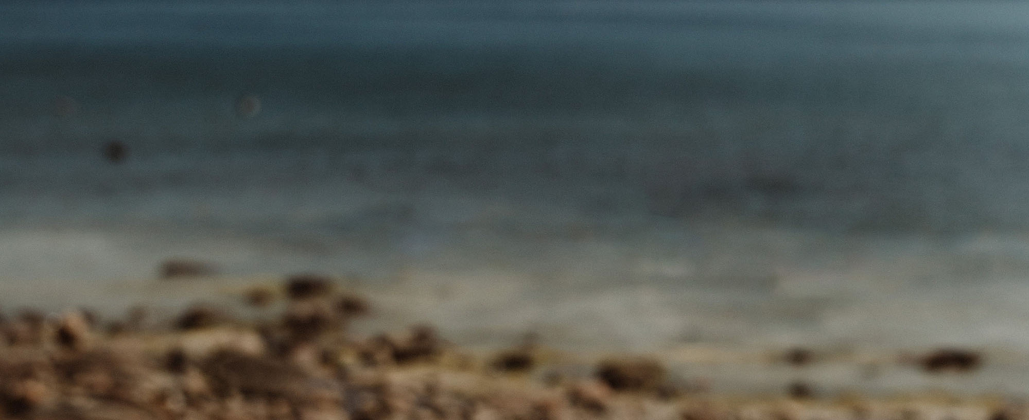 Grainy image of an ocean and beach.