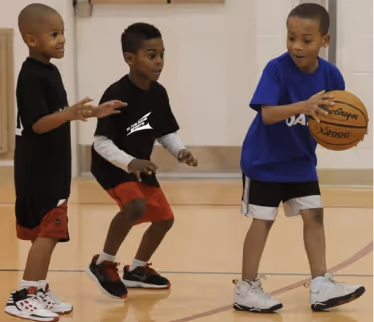Students playing basketball in the school gym