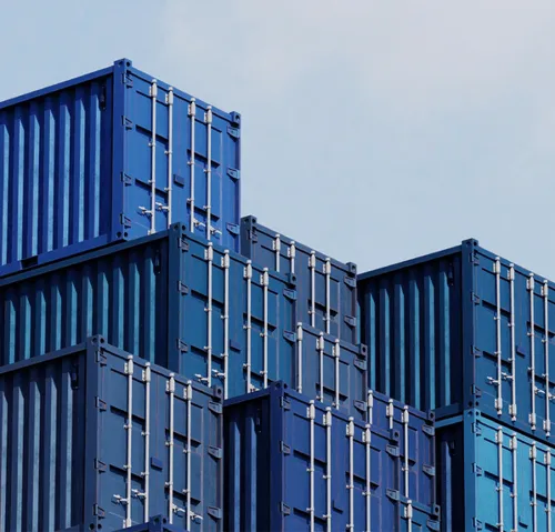 Blue shipping containers stacked against the sky