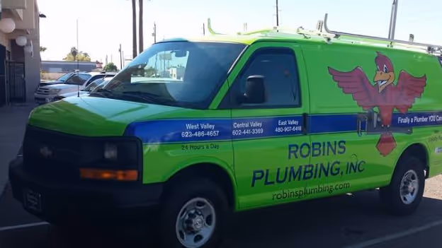Green Robins Plumbing Inc. van with bird logo and contact numbers for West Valley, Central Valley, and East Valley.