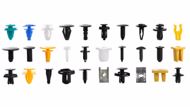 Various automotive door fasteners in different colors and shapes arranged in three rows on a white background.