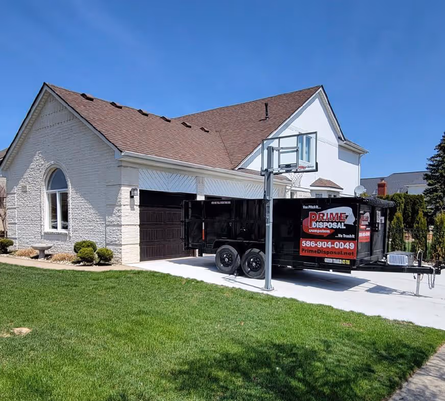 Trailer parked in driveway for sterling heights junk removal, professional junk removal service offering same day junk removal at a home in sterling heights mi.