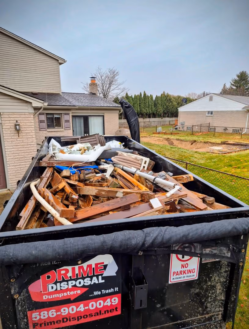 Prime disposal crew clearing out a crowded residential garage for a royal oak junk removal project.