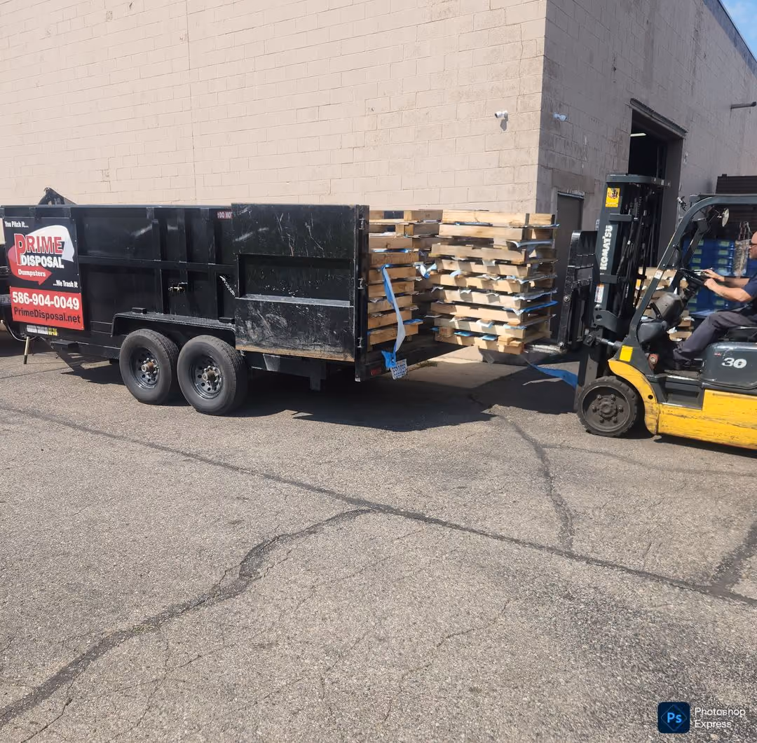 Oakland county junk removal crew dismantling wood flooring for a commercial property renovation