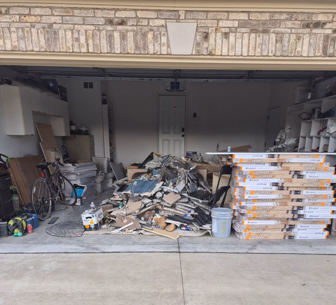 Oakland county junk removal crew dismantling wood flooring for a commercial property renovation