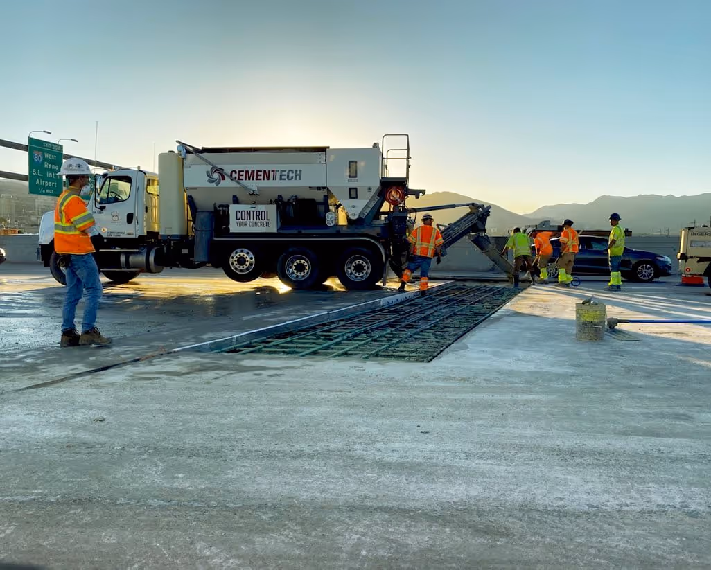 Men working on freeway at dawn.