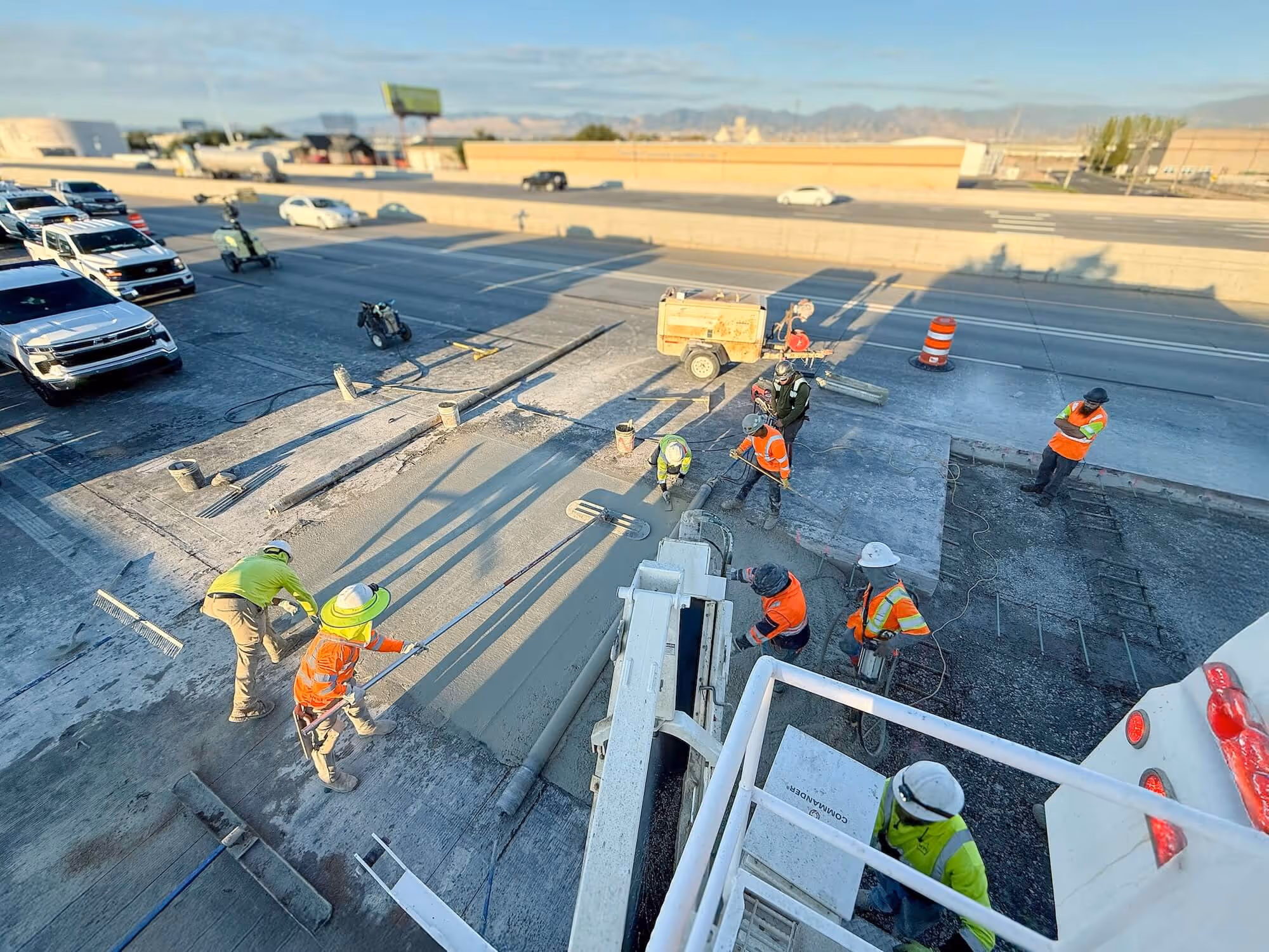 Workers pouring concrete on highway