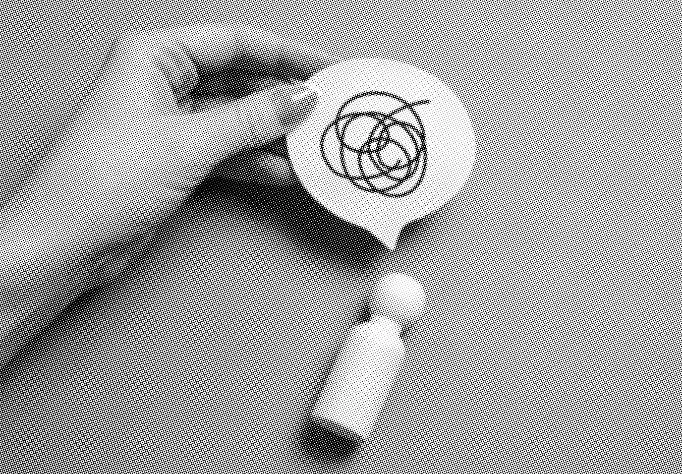 grayscale halftone image of a wooden person and a paper speech bubble with a confusion scribble on it, being held up by someone's hand on a plain background