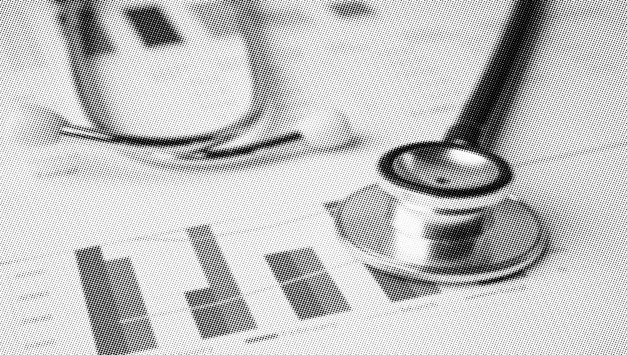 grayscale halftone image of a close up of a stethoscope on top of papers with bar charts