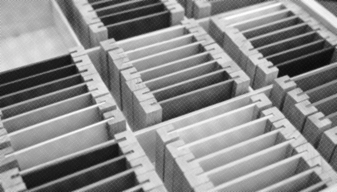 grayscale halftone image of wooden boxes with sorted slices of wood panels painted in different colours