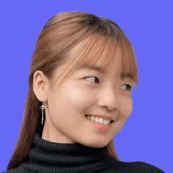 Young woman with light brown hair, smiling and looking to her left, wearing a black turtleneck.
