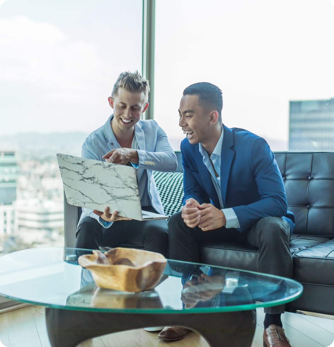 Two people looking at laptop