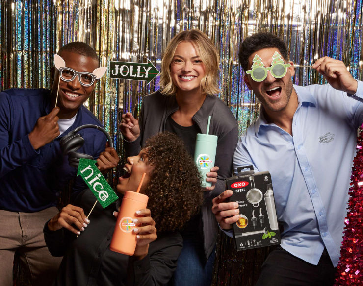 An image of employees holding branded gifts