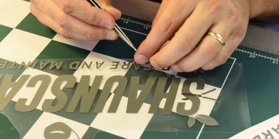 An image of someone preparing vinyl printing.