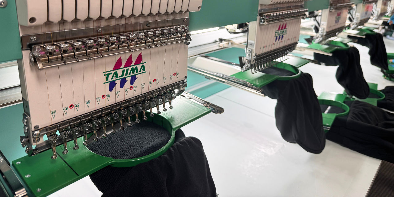 An image of our embroidery machines embroidering a design on custom toques