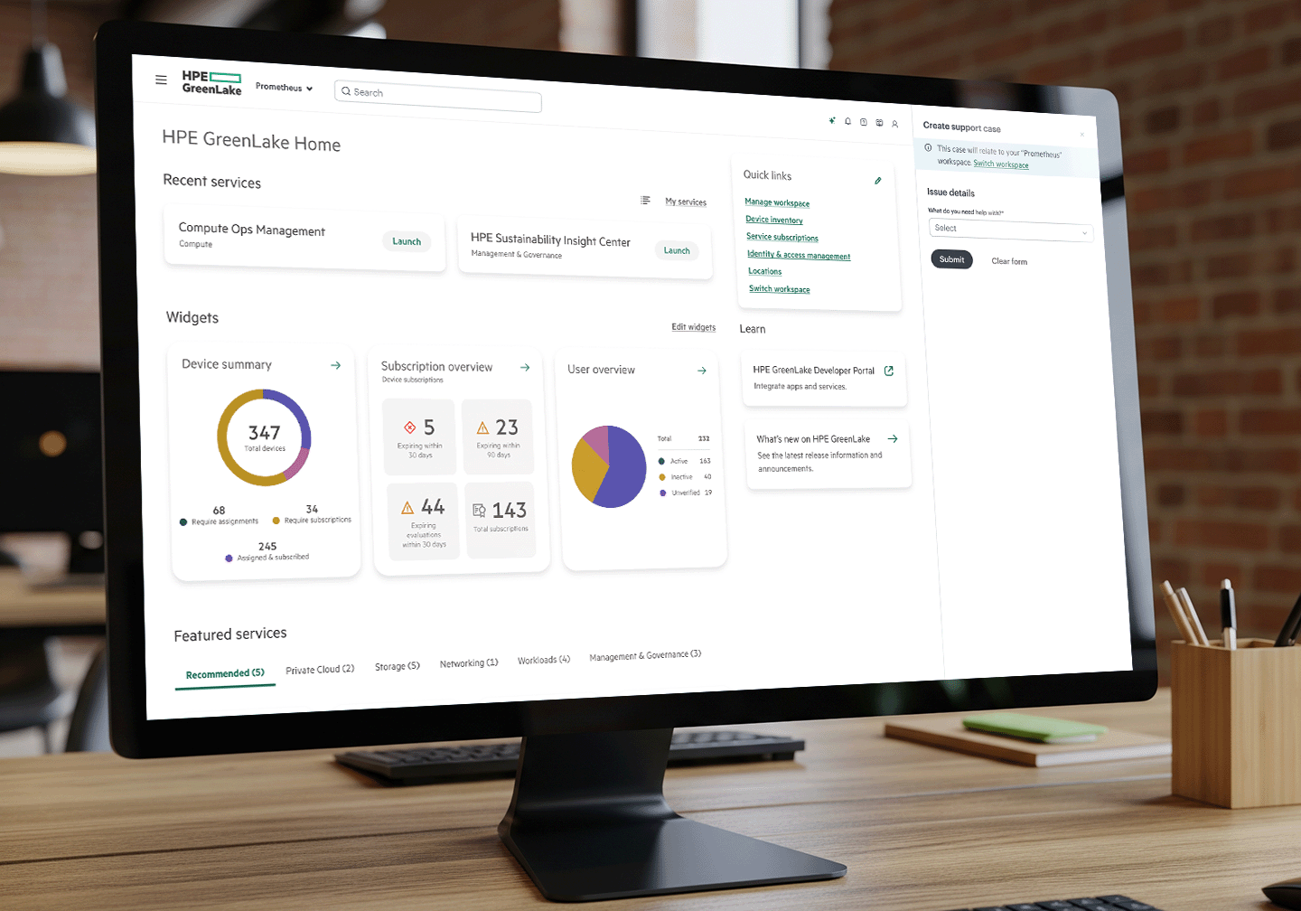 Desktop monitor displaying HPE GreenLake Home interface with recent services, widgets for device summary, subscription overview, user overview, quick links, and support case creation form.