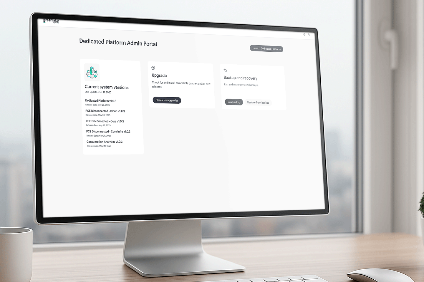 Computer monitor on a desk showing a Dedicated Platform Admin Portal with system version details, upgrade and backup options.