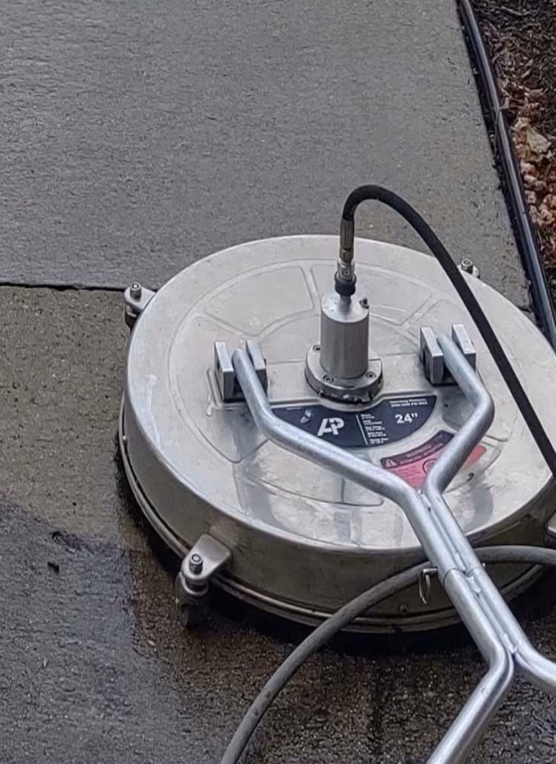 Rotary surface cleaner washing a concrete driveway