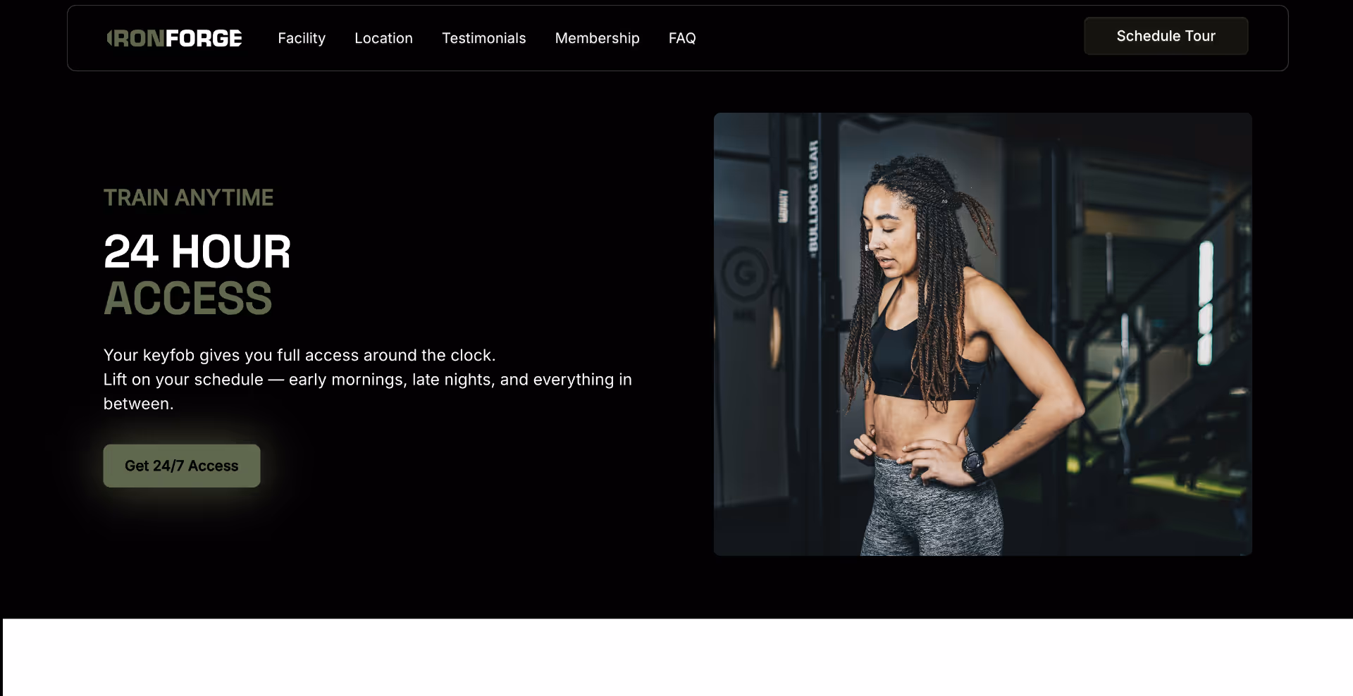 Fit woman with long braided hair wearing a sports bra and leggings in a gym, hands on hips and catching her breath.