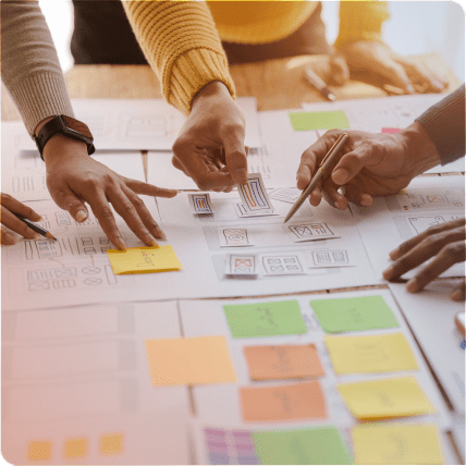UX Researchers sorting paper notes at a table