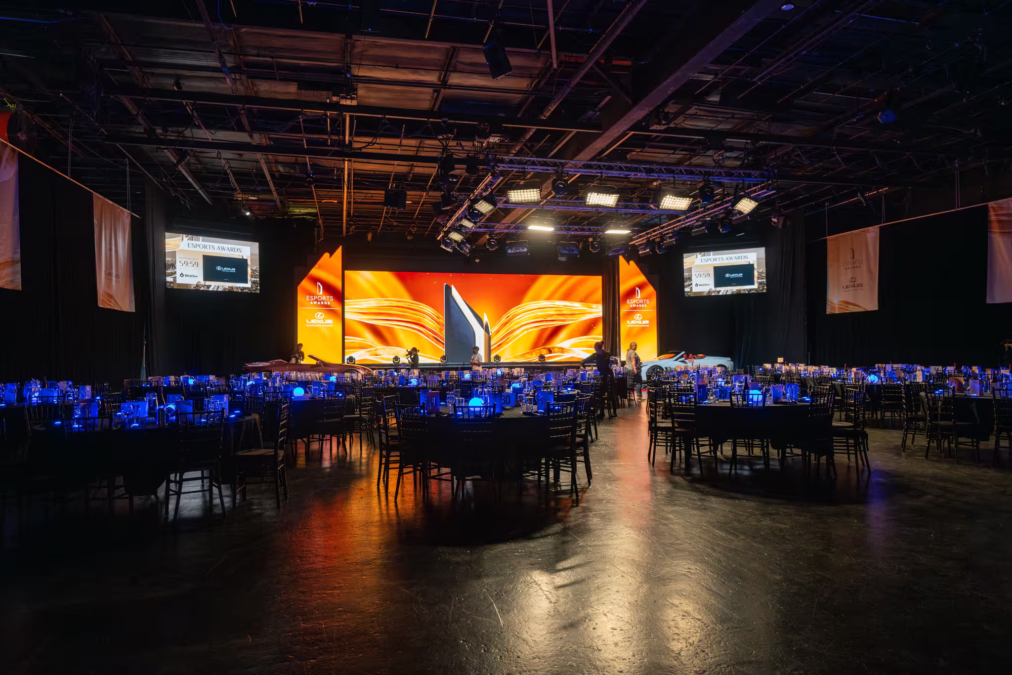 A large seated company event with stage and screen at Thunder Studios