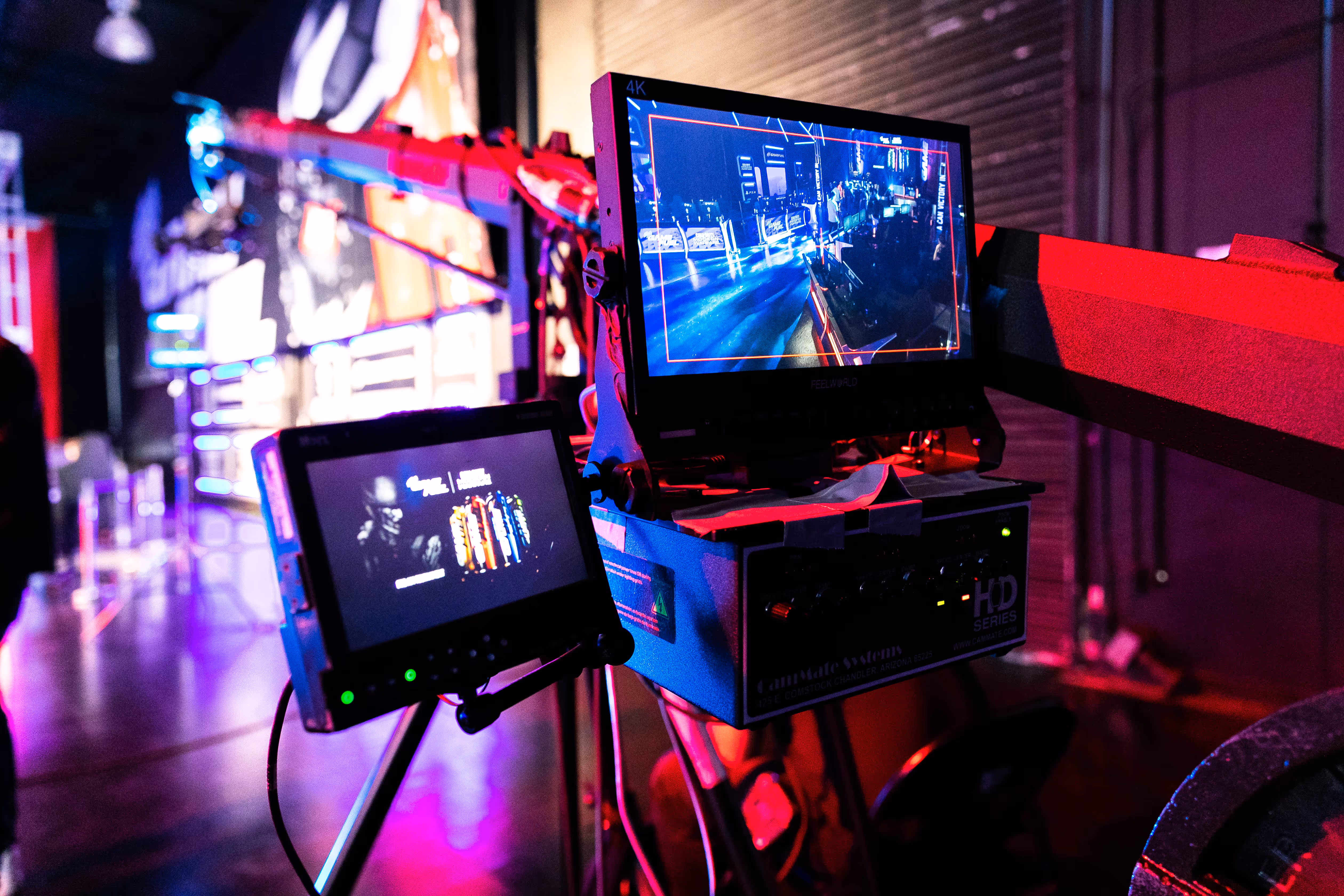 A 4K monitor and camera control unit showing the live feed at an esports broadcast