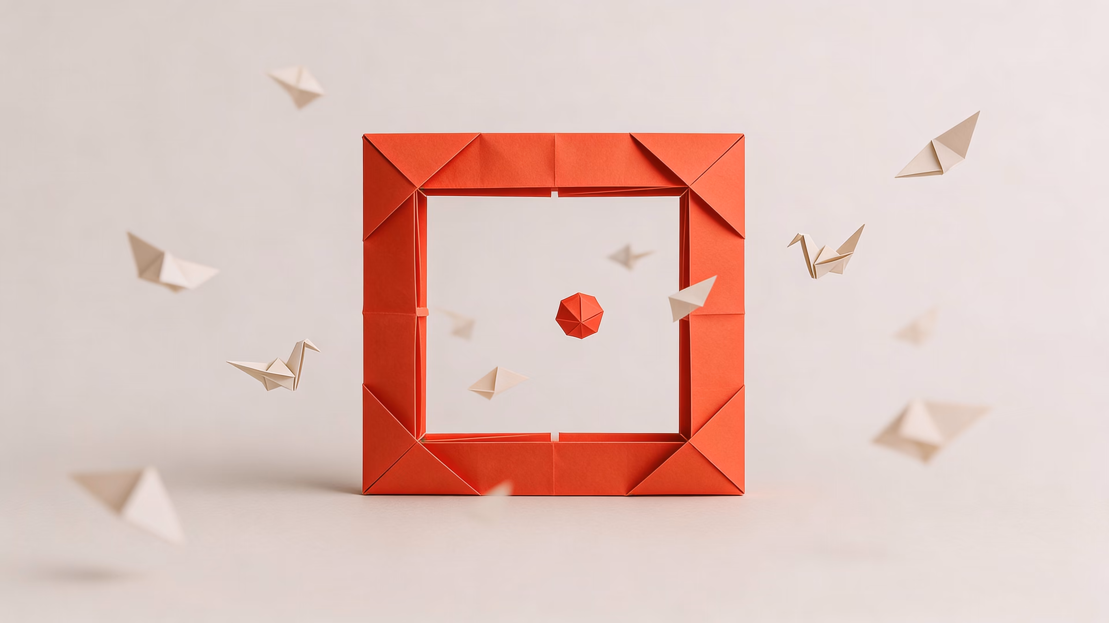 Red origami frame with a red origami polyhedron inside, surrounded by beige origami birds on a neutral background.