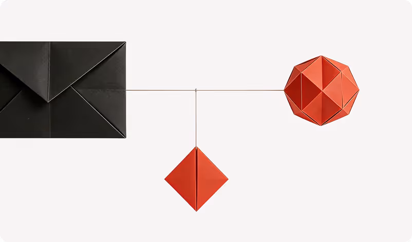 Black paper envelope connected by thin strings to two red geometric origami shapes on a white background.