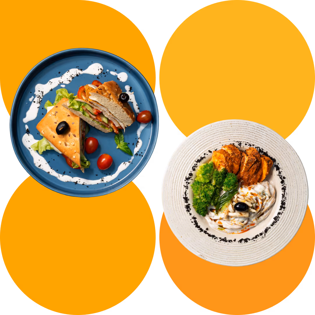 Blue plate with sandwich halves and tomatoes; white plate with chicken, broccoli, and a creamy sauce.