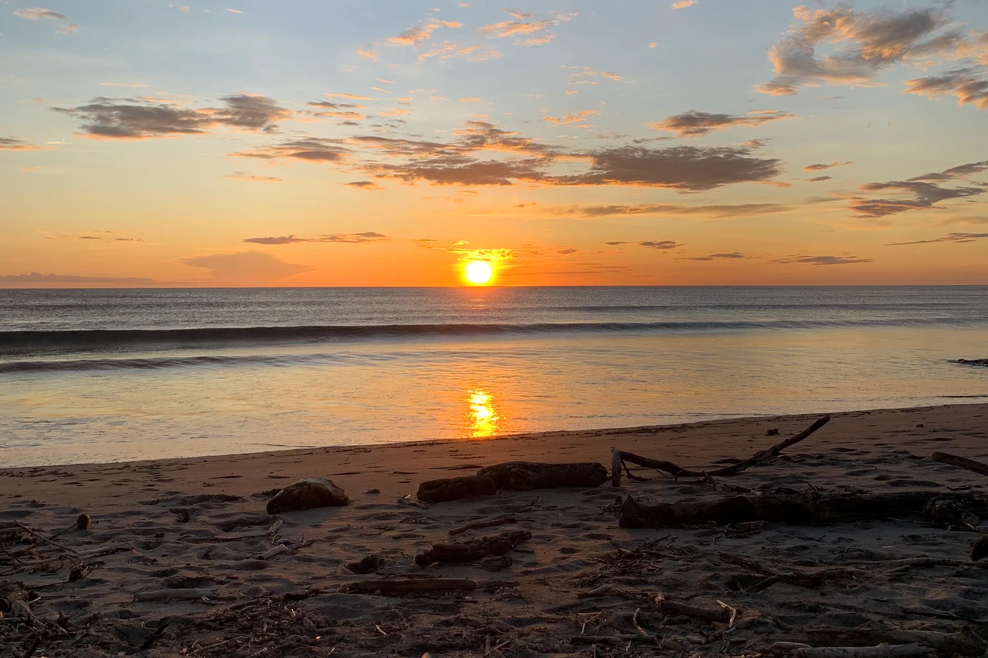 The sun setting over the Pacific Ocean along a beach in Costa Rica