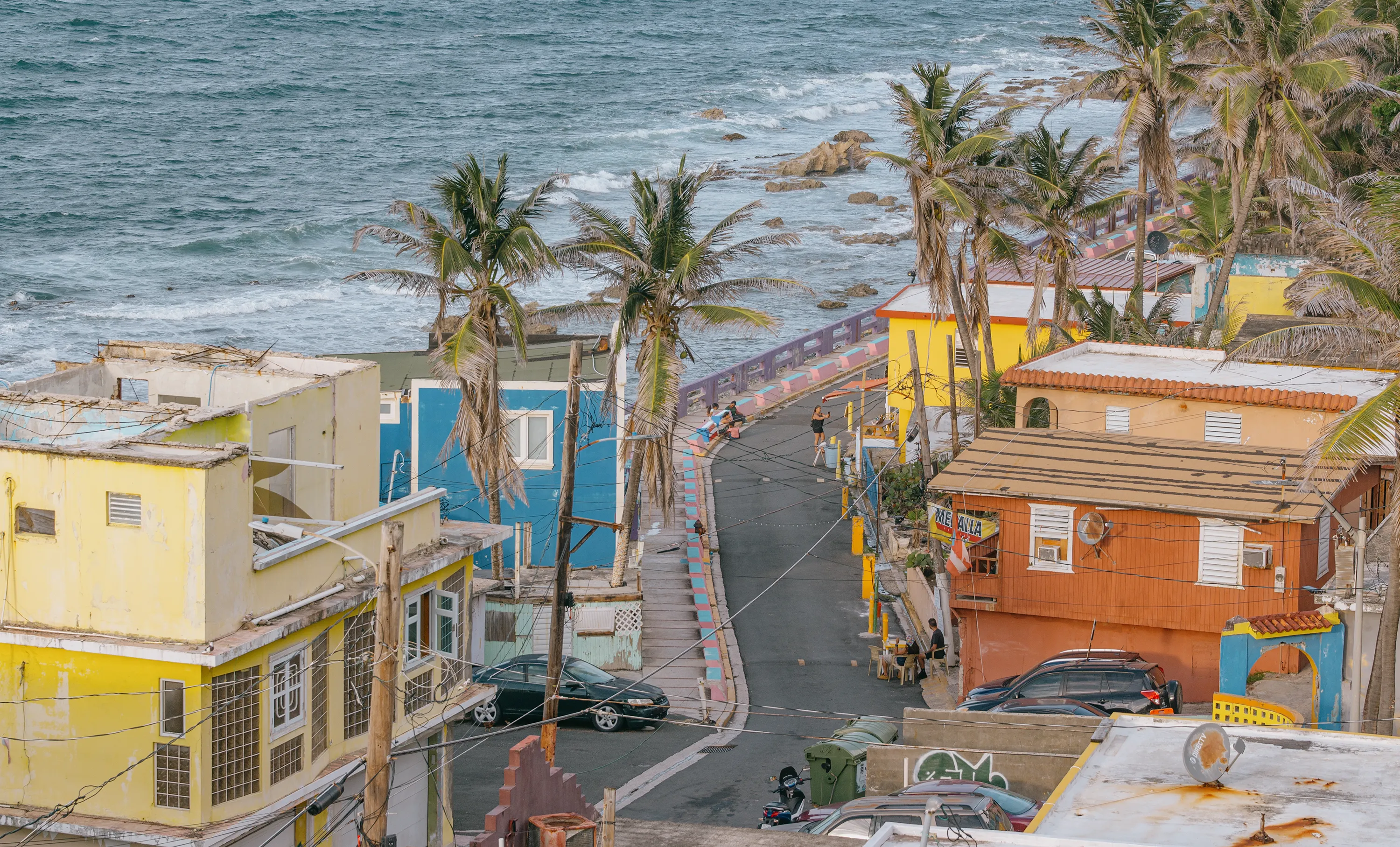 Brightly painted houses lined along a coastal street in Puerto Rico
