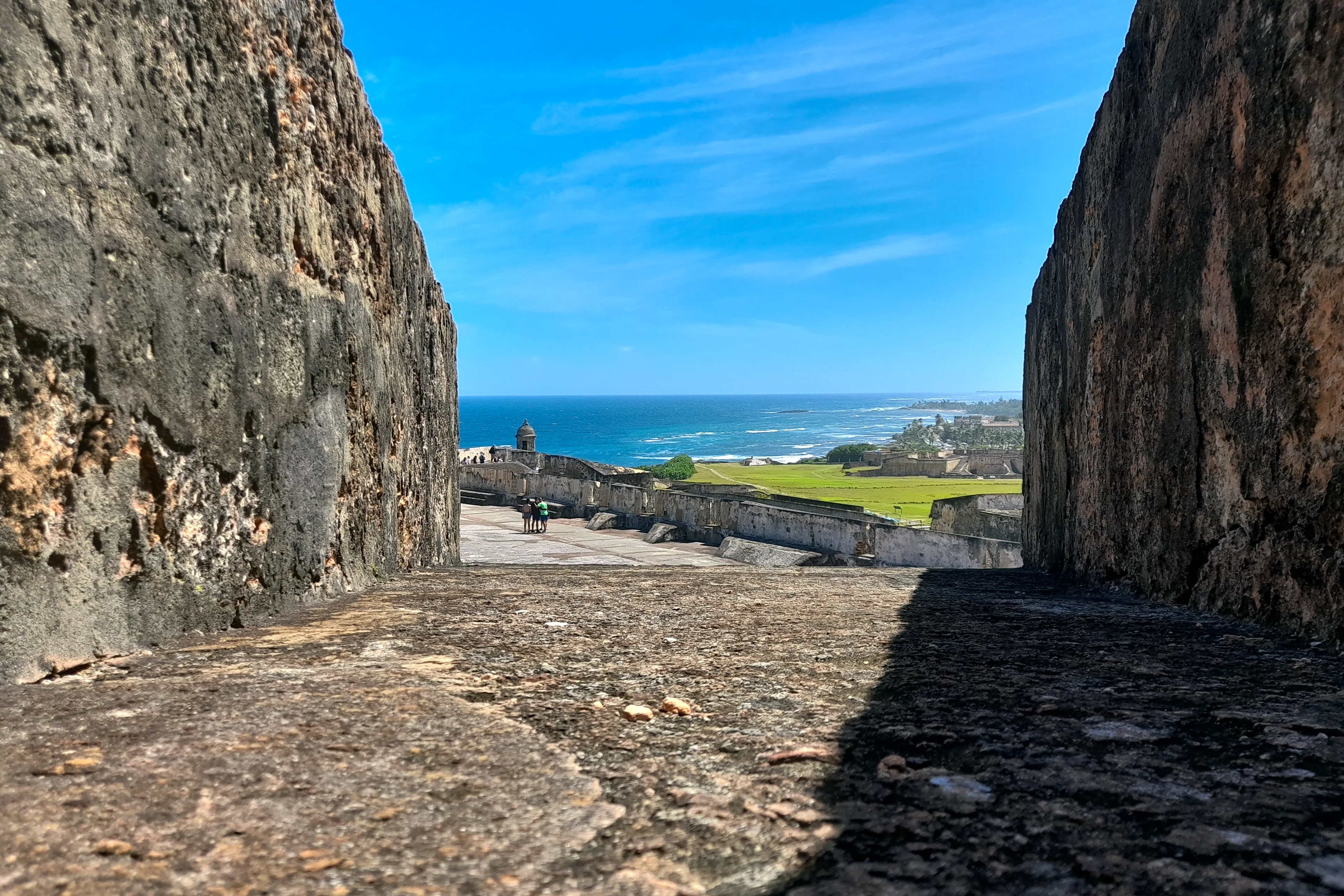 A view of the ocean through the stone walls of a historic Spanish fort in San Juan, Puerto Rico