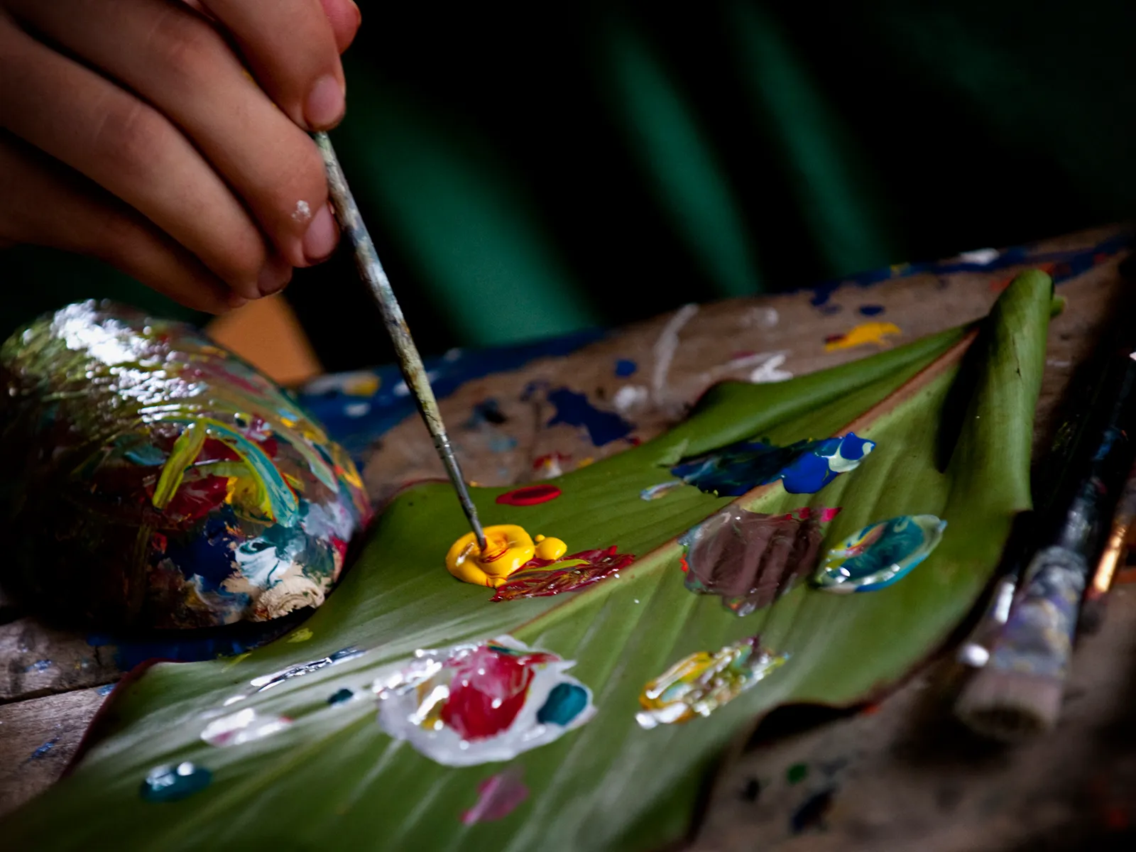 Close-up of hands painting a colorful craft during an art activity in Costa Rica