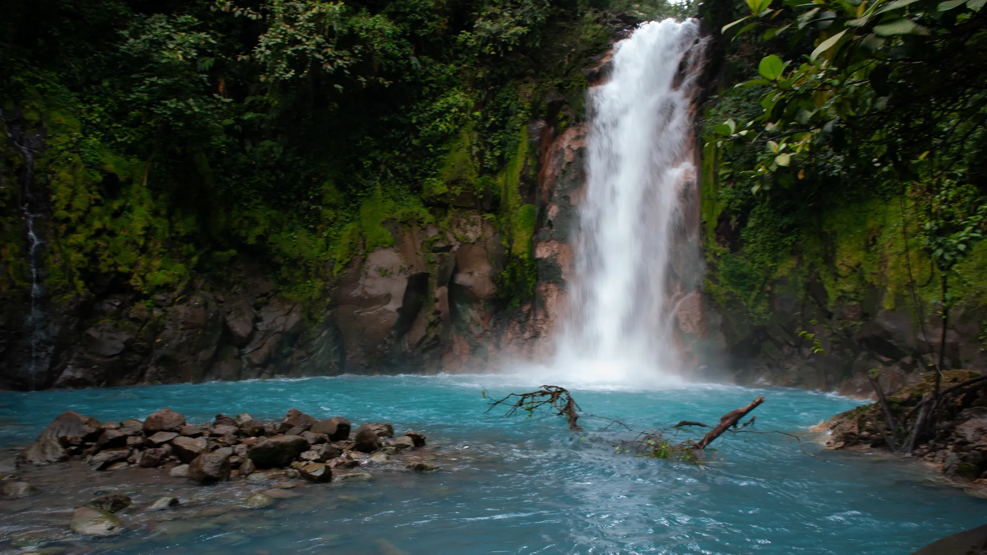 A waterfall spilling into a pool in the Costa Rica rainforest