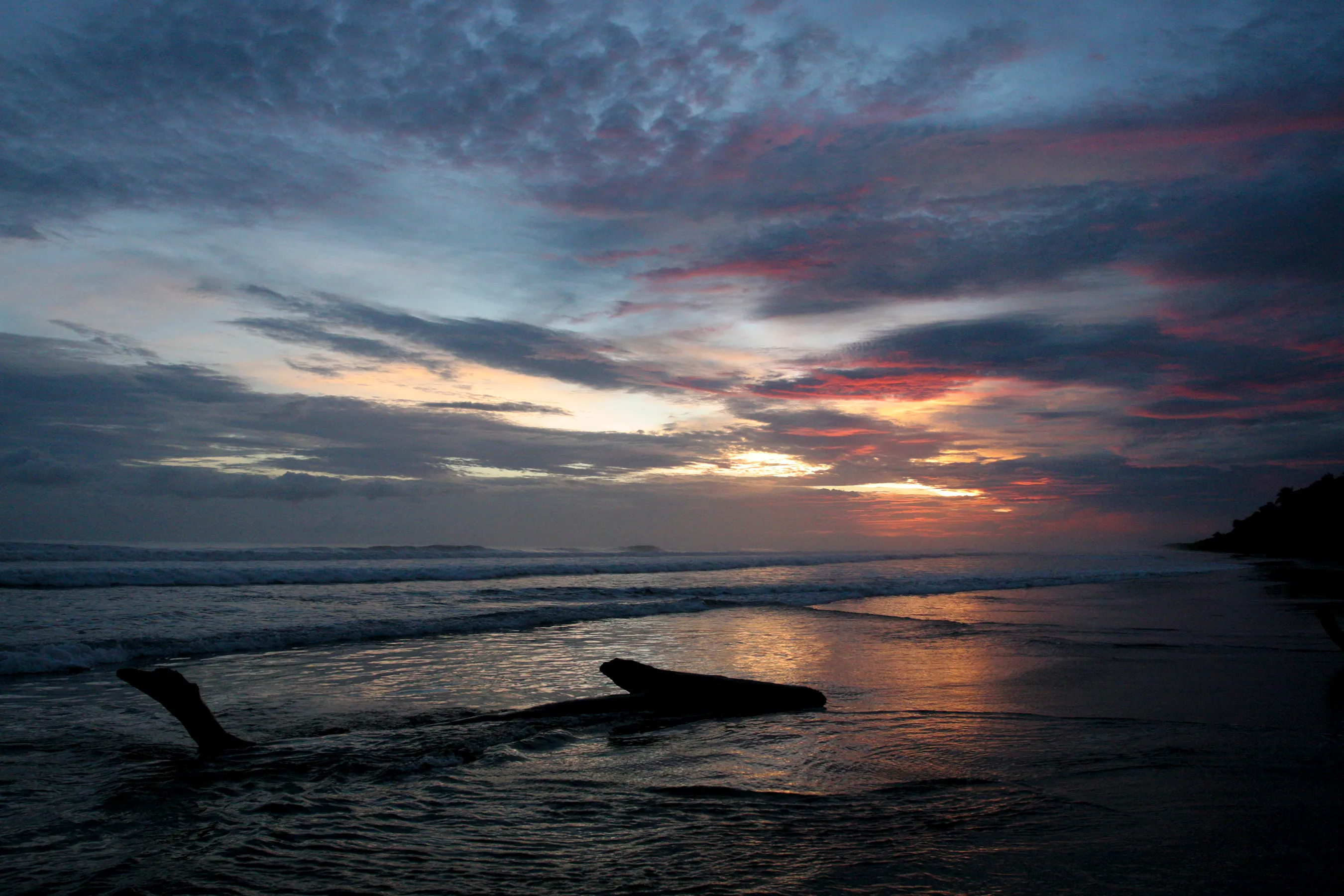 The sun setting over the ocean along a beach in Costa Rica