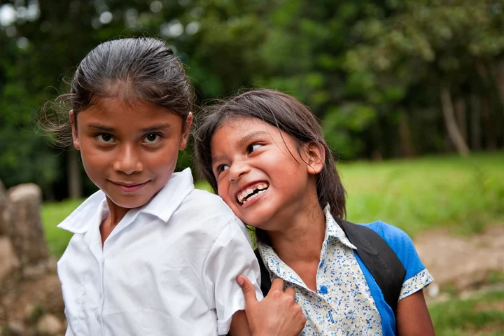 Two children smiling and laughing together in Costa Rica