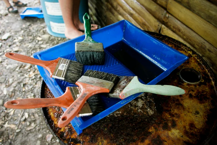 Paintbrushes and rollers on a paint tray during a community service project in Costa Rica